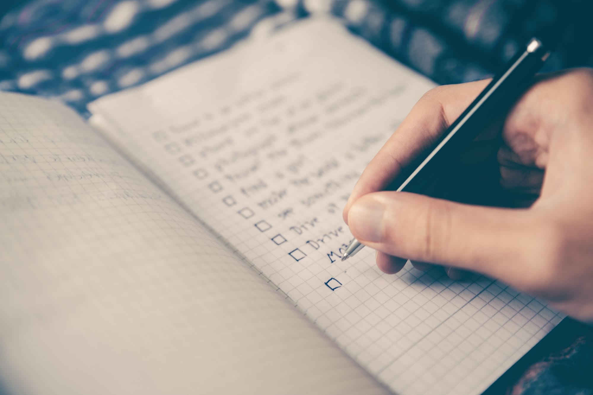 a person sitting down goal setting in a journal