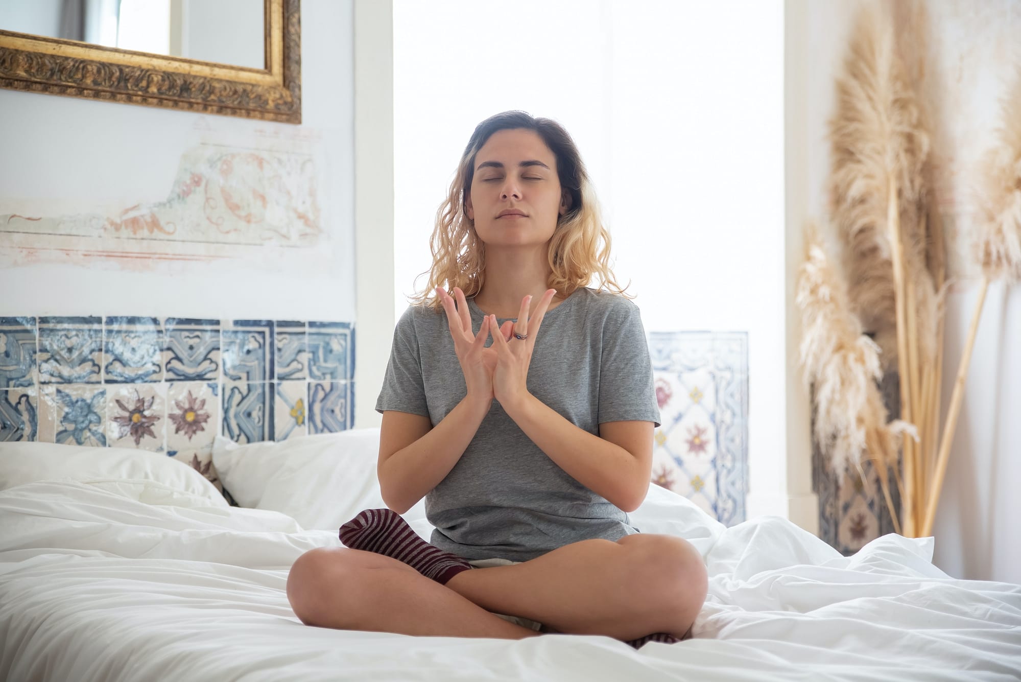 can you meditate in bed - a girl in her bed meditating