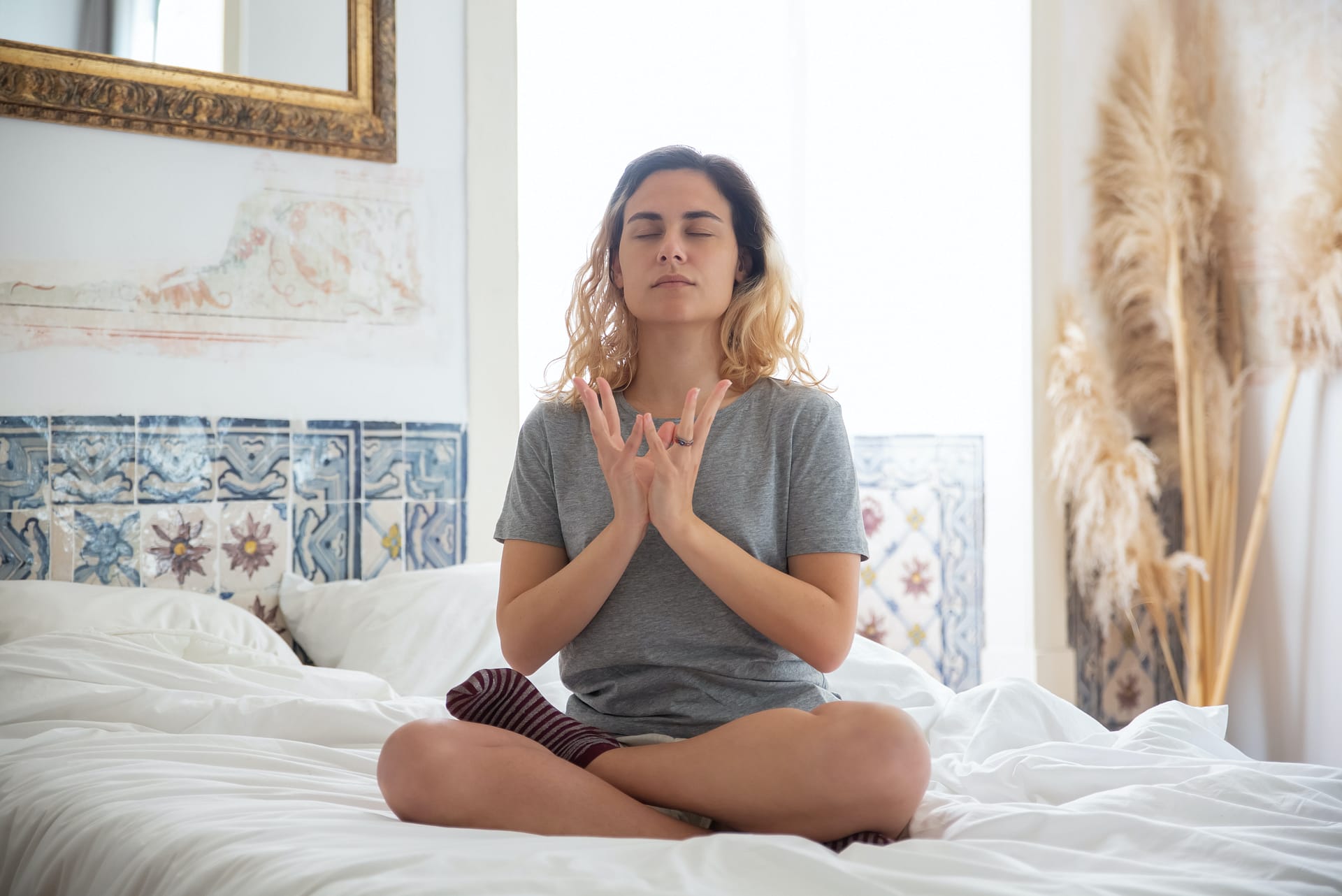 can you meditate in bed - a girl in her bed meditating